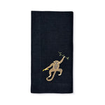 Servilleta Tropic de lino negro con bordado de chango con plátano, marca Zash