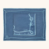 Mantelería Cowgirl con Individuales y Servilletas en Lino Azul con Bordado Teal. Set para 4 personas.