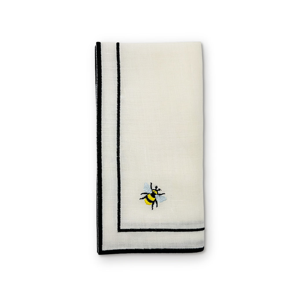 Servilleta Jimmy de lino blanco con doble orilla bordada en negro y abeja 