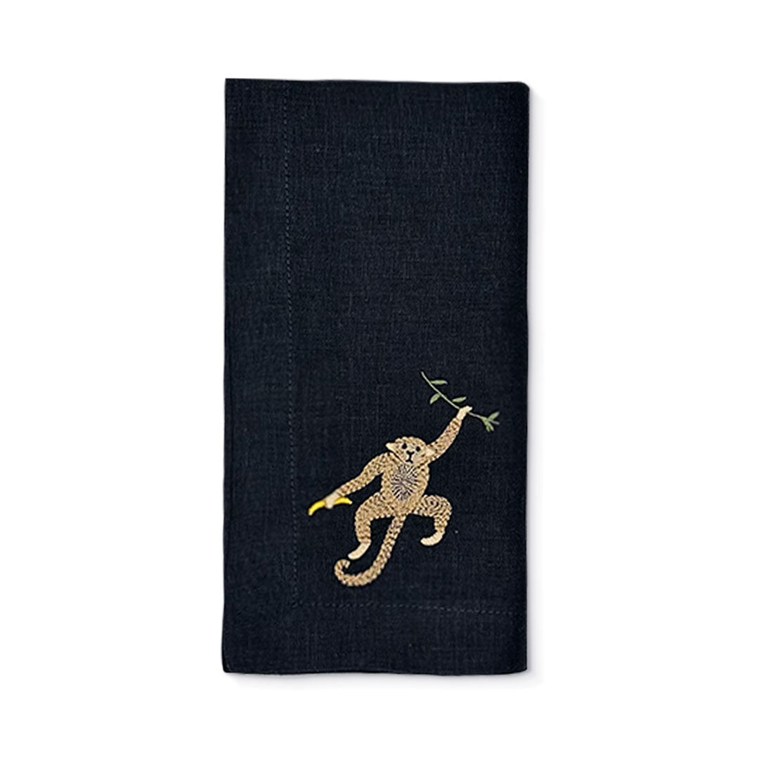 Servilleta Tropic de lino negro con bordado de chango con plátano, marca Zash
