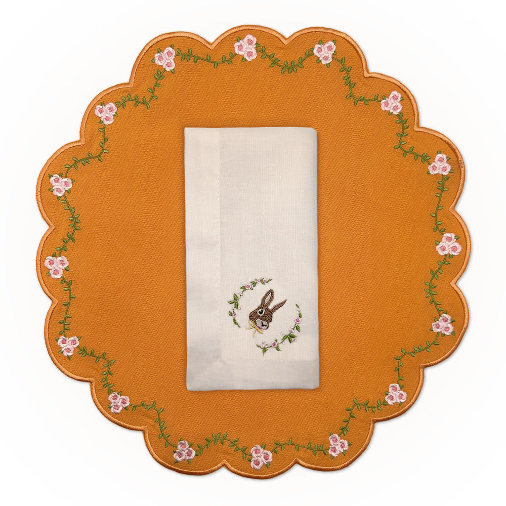 Set de mantelería con Individuales Pily en algodón naranja con bordado de flores y servilleta de lino con conejo bordado, marca Zash