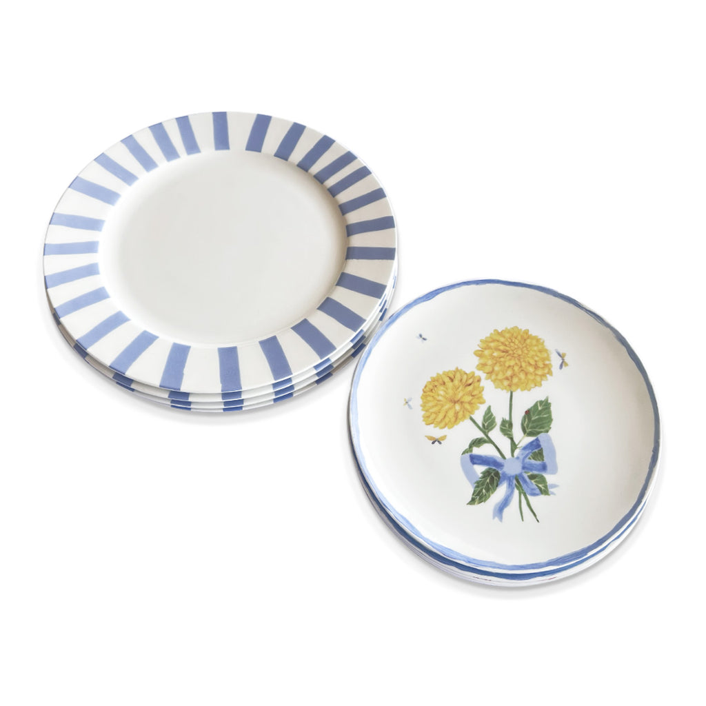 Set de vajilla con platos trinche con rayas azules y plato de ensalada con ilustración de dalias y listón azul, marca Zash