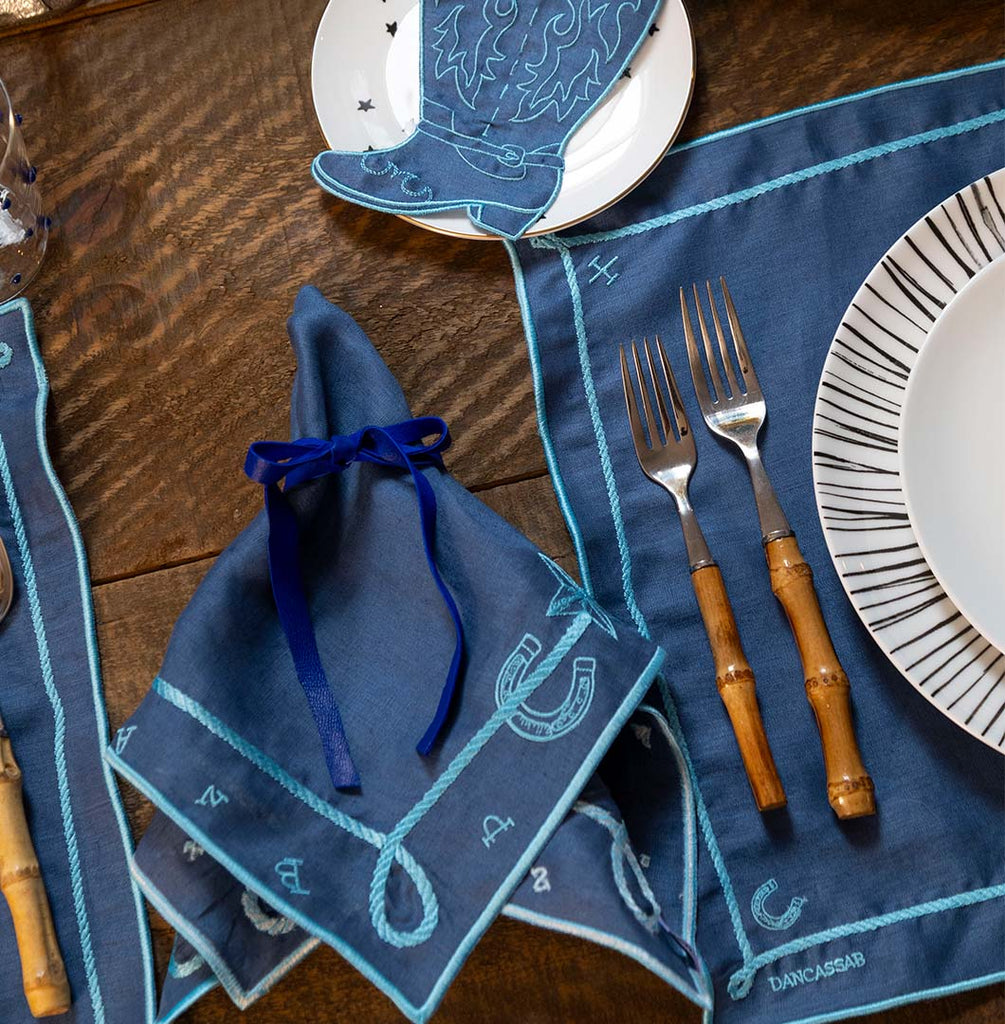 Mantelería Cowgirl con Individuales y Servilletas en Lino Azul con Bordado Teal. Set para 4 personas.